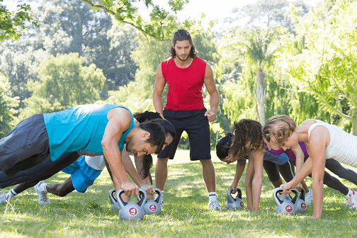 fitness-group-planking-park-with-coach 1